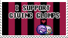 a stamp of two deviantart emoticons hugging that has text on it saying 'i support giving glomps'. the stamp has a dull red and black striped background.